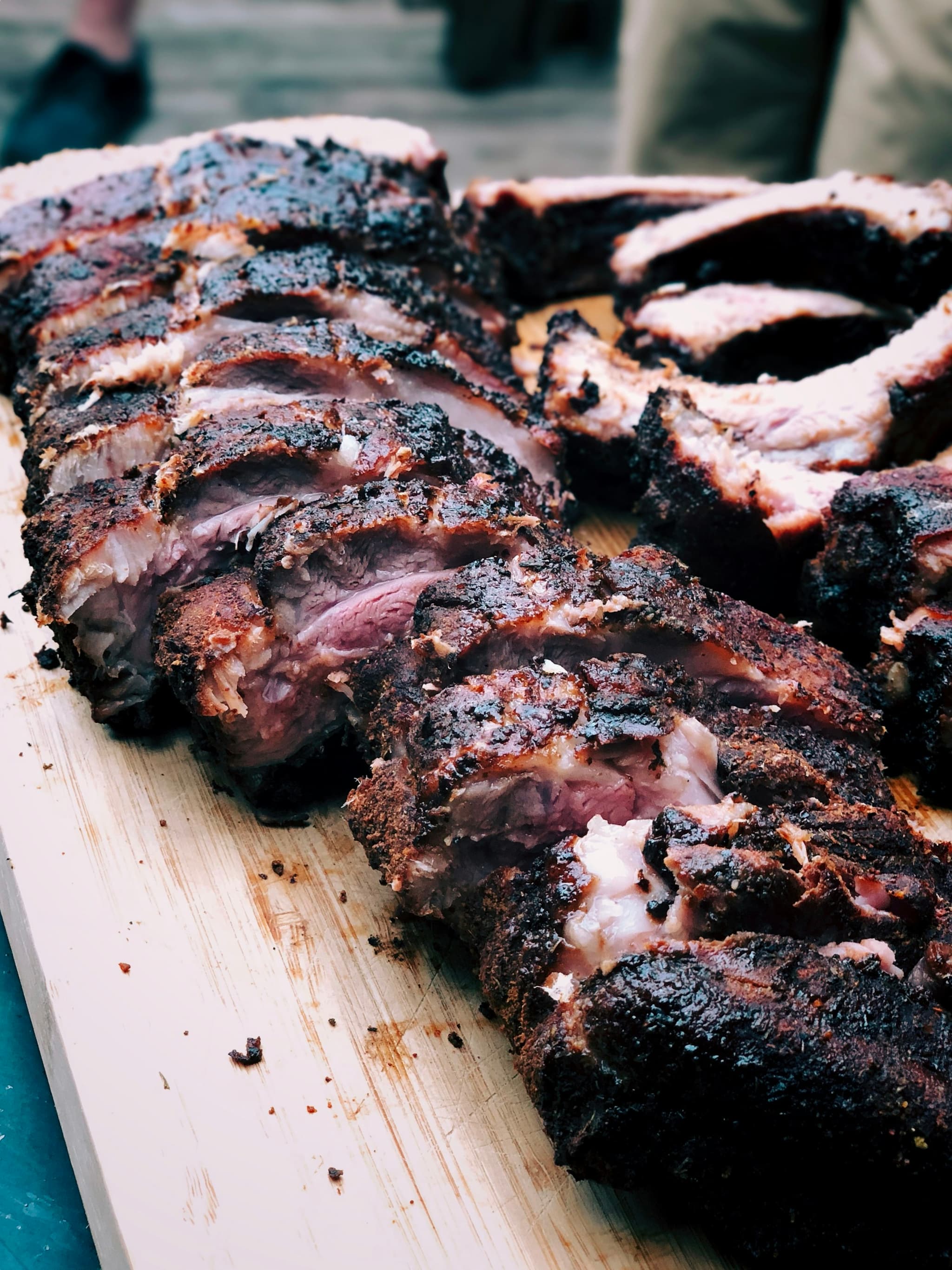 Smoked brisket over a hot grill with fire and smoke